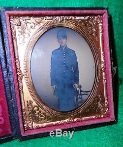 CASED DAGUERREOTYPE of YOUNG CIVIL WAR SOLDIER in CAP & FROCK COAT, HAND COLORED