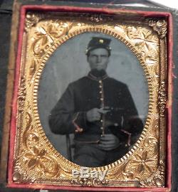 Nicely hand tinted tintype of an Civil War artillery soldier withrevolver